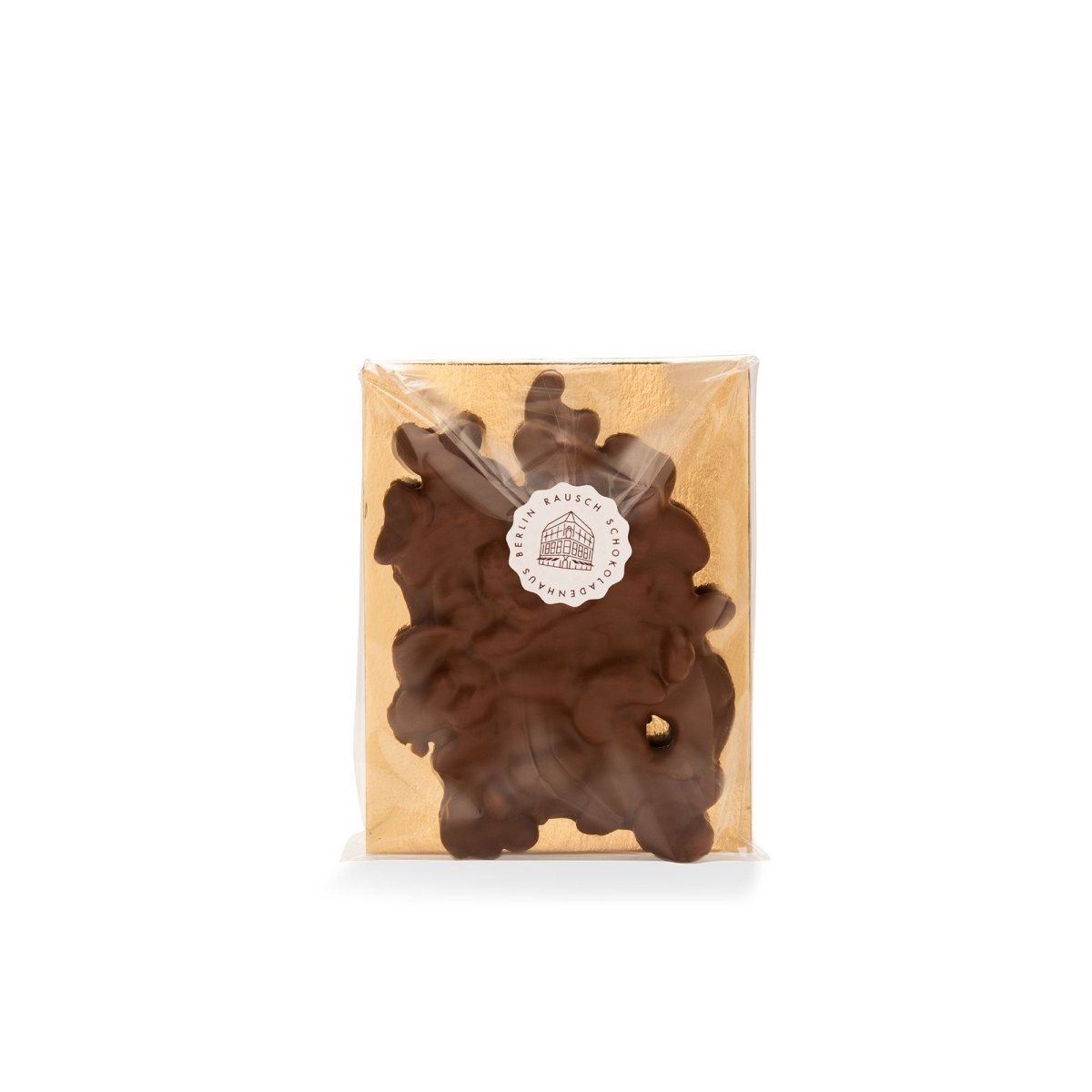 Verpackte Schokoladentafel mit Cashewnüssen, goldener Hintergrund, Logo-Aufkleber in der Mitte.