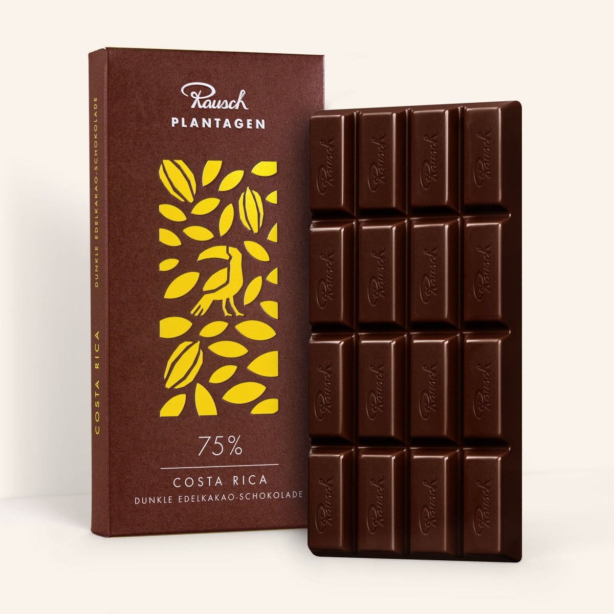 Rausch Costa Rica 75% Edelkakao-Schokolade, Tafel vor goldgelber Verpackung mit Kakaomotiv.