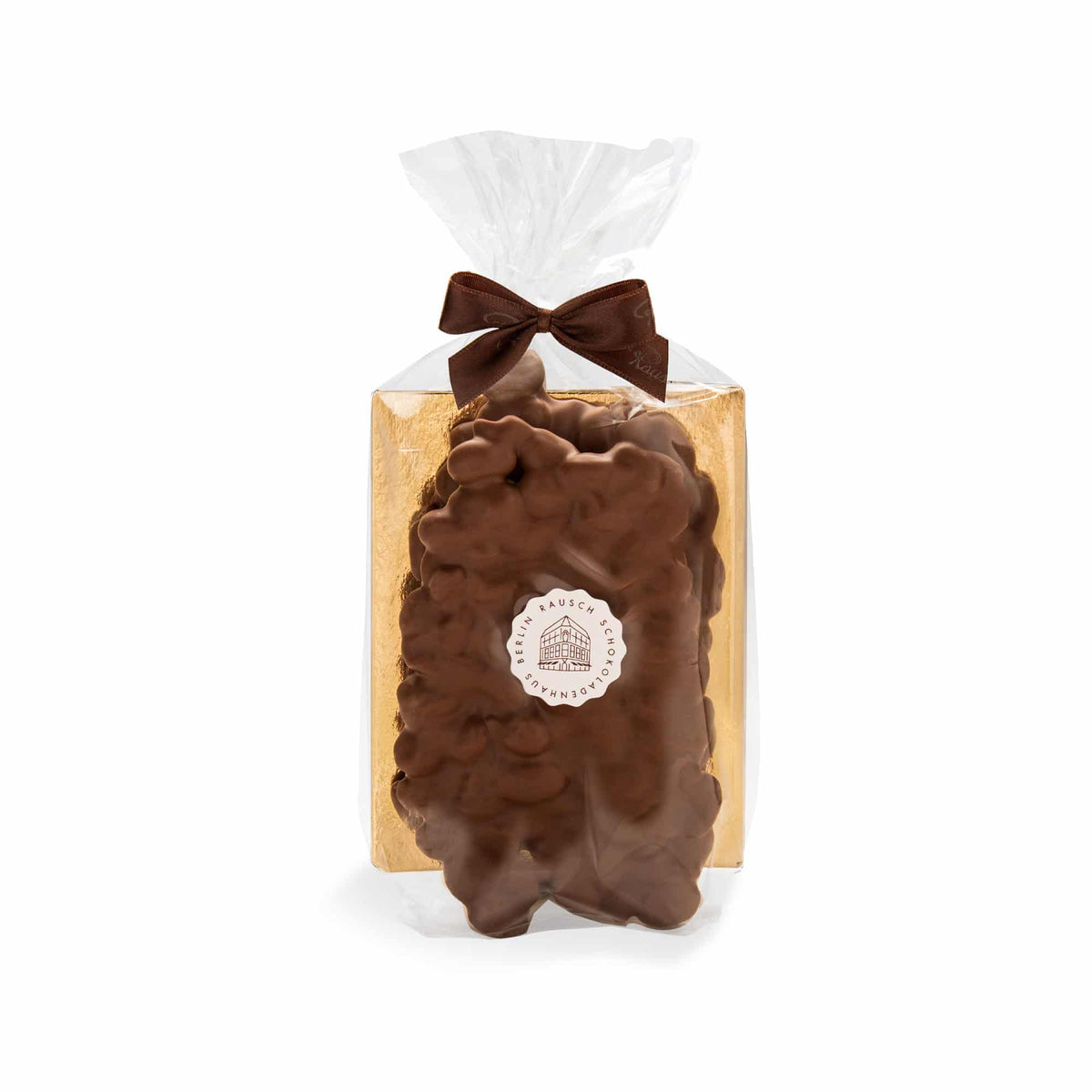 Goldene Verpackung mit Schokolade und Mandeln, verziert mit brauner Schleife, von Rausch Schokoladen.