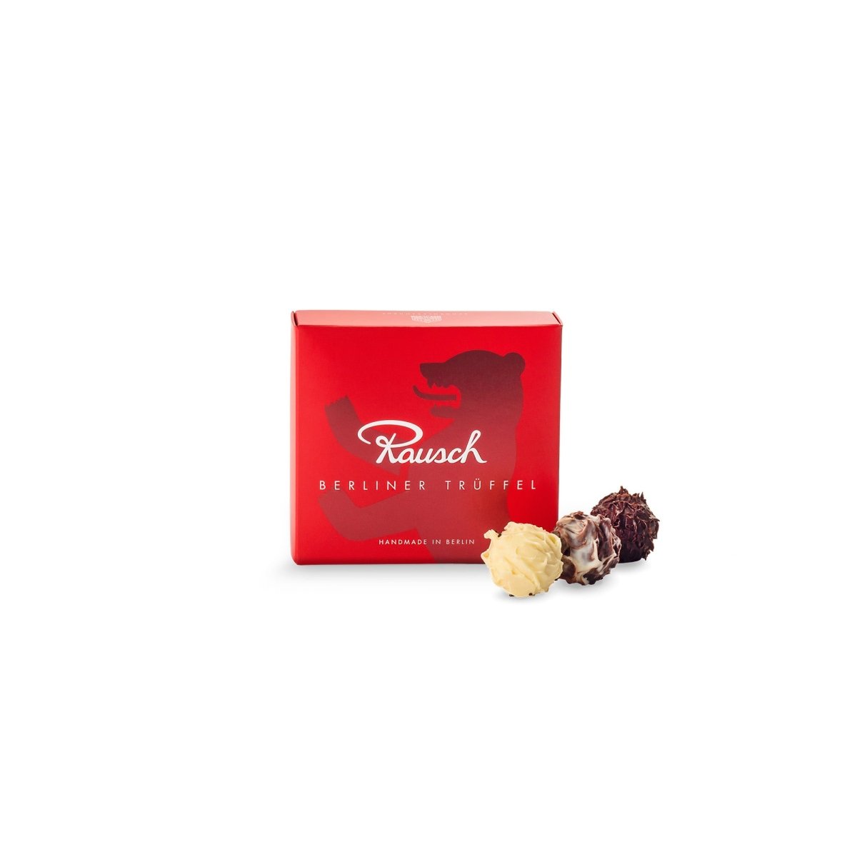 Rote Schachtel mit Rausch-Logo und Berliner Trüffeln, drei Pralinen davor.