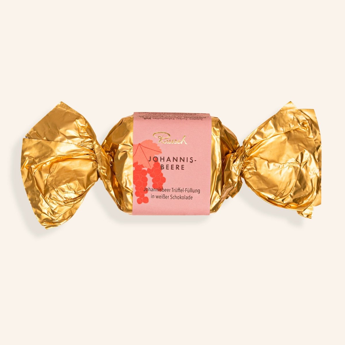 Goldene Verpackung mit Johannisbeer-Happen in weißer Schokolade von Rausch.