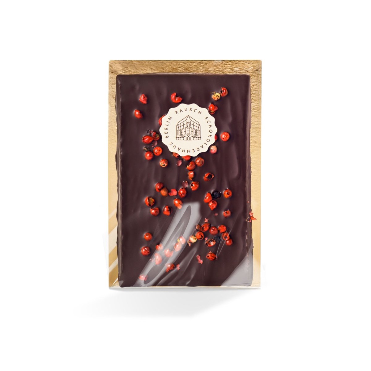 Tafel Edelbitterschokolade mit rosa Pfefferkörnern, verpackt in einer dekorativen Schachtel.