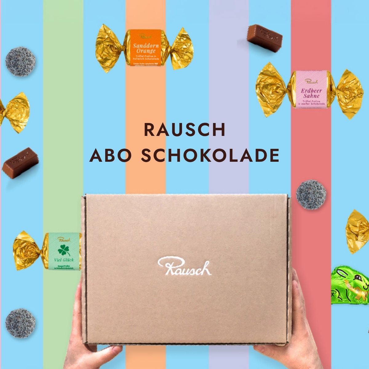 Hände halten eine Rausch-Schokoladenbox, umgeben von farbenfrohen Pralinen auf blauem Hintergrund.