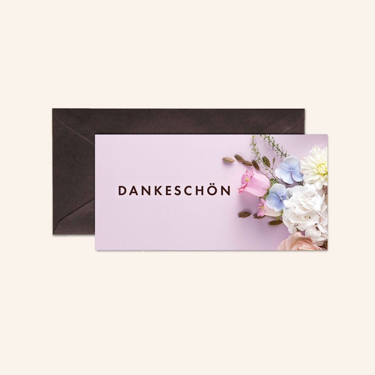 Grußkarte mit "Dankeschön"-Aufschrift und Blumenmotiv, Umschlag daneben.
