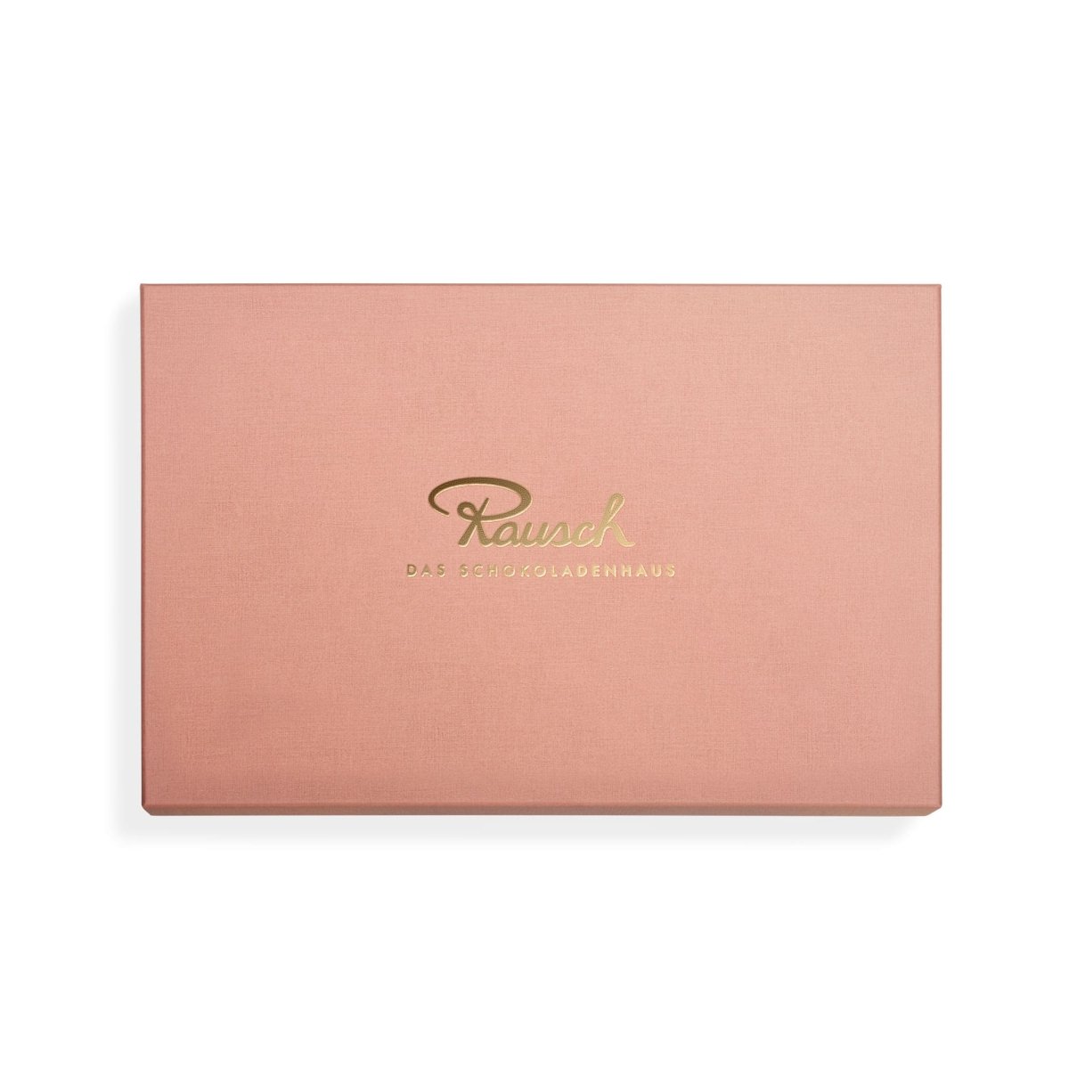Rosa Pralinen-Geschenkbox von Rausch mit goldfarbenem Logo auf dem Deckel.