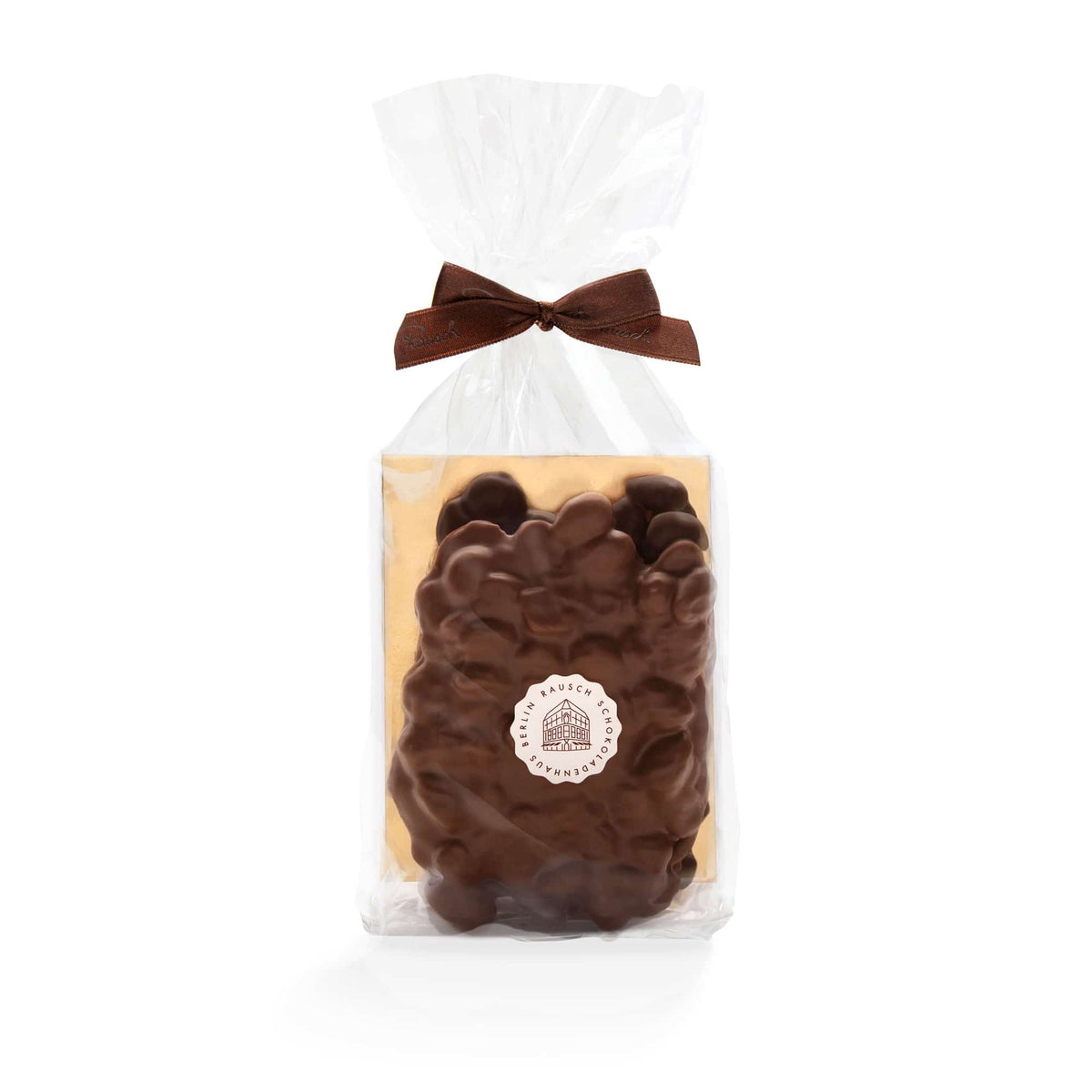 Verpackung mit schokolierten Nüssen, elegant mit Schleife verziert, von Rausch Schokoladen.
