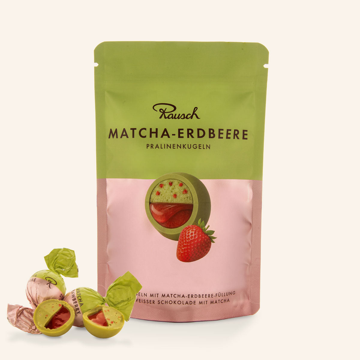 Päckchen handwerkliche Matcha-Erdbeer-Pralinenkugeln mit grüner und rosa Schokolade. - Rausch