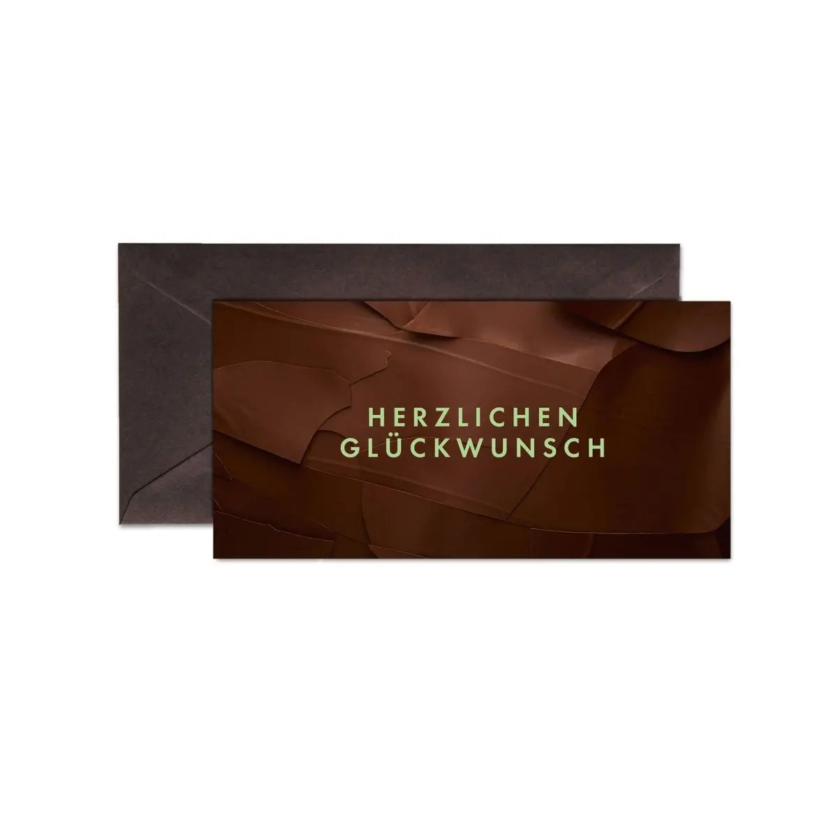 Dunkle Karte mit "Herzlichen Glückwunsch" in goldener Schrift auf zartem Schokoladenhintergrund, brauner Umschlag.