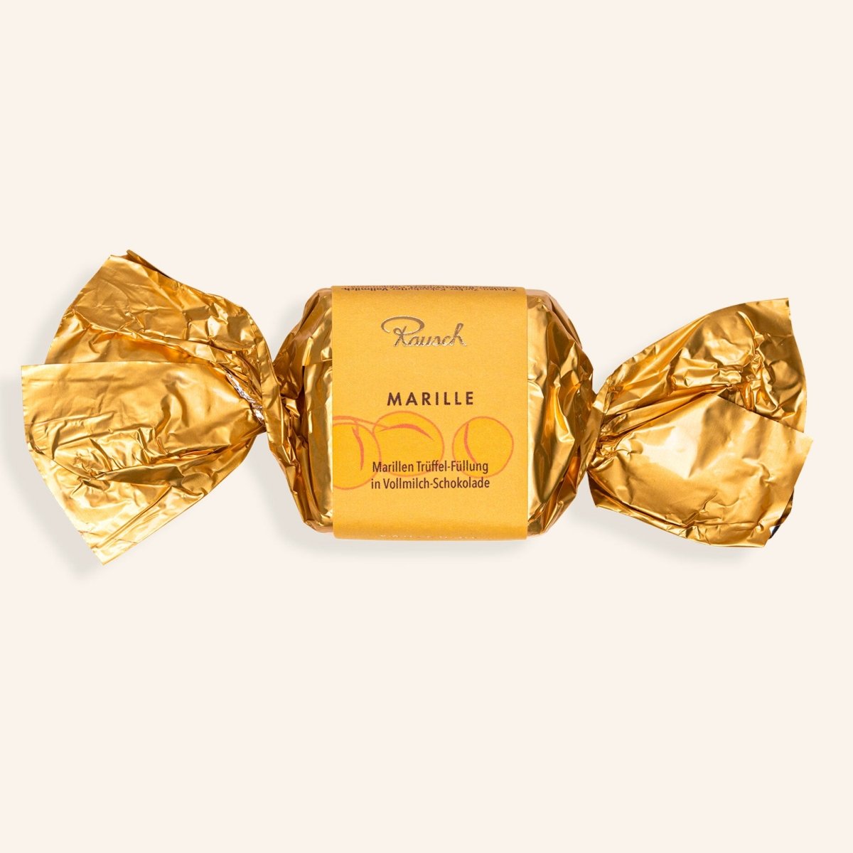 Goldfolienverpackter Happen mit Marille-Trüffel-Füllung in Vollmilch-Schokolade von Rausch.