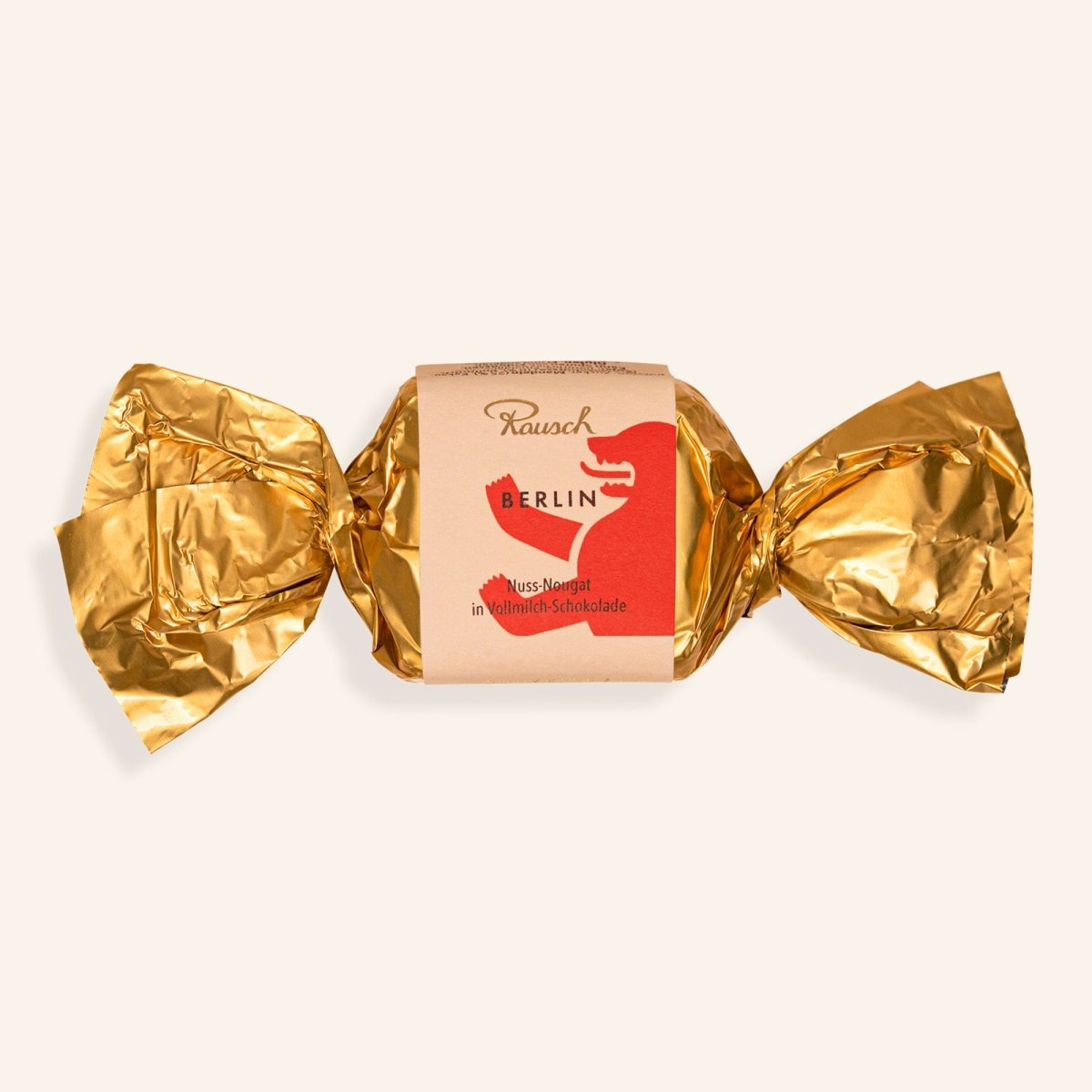 Goldverpackter Schokoladen-Happen "Berliner Bär" von Rausch, gefüllt mit Haselnuss-Nougat.