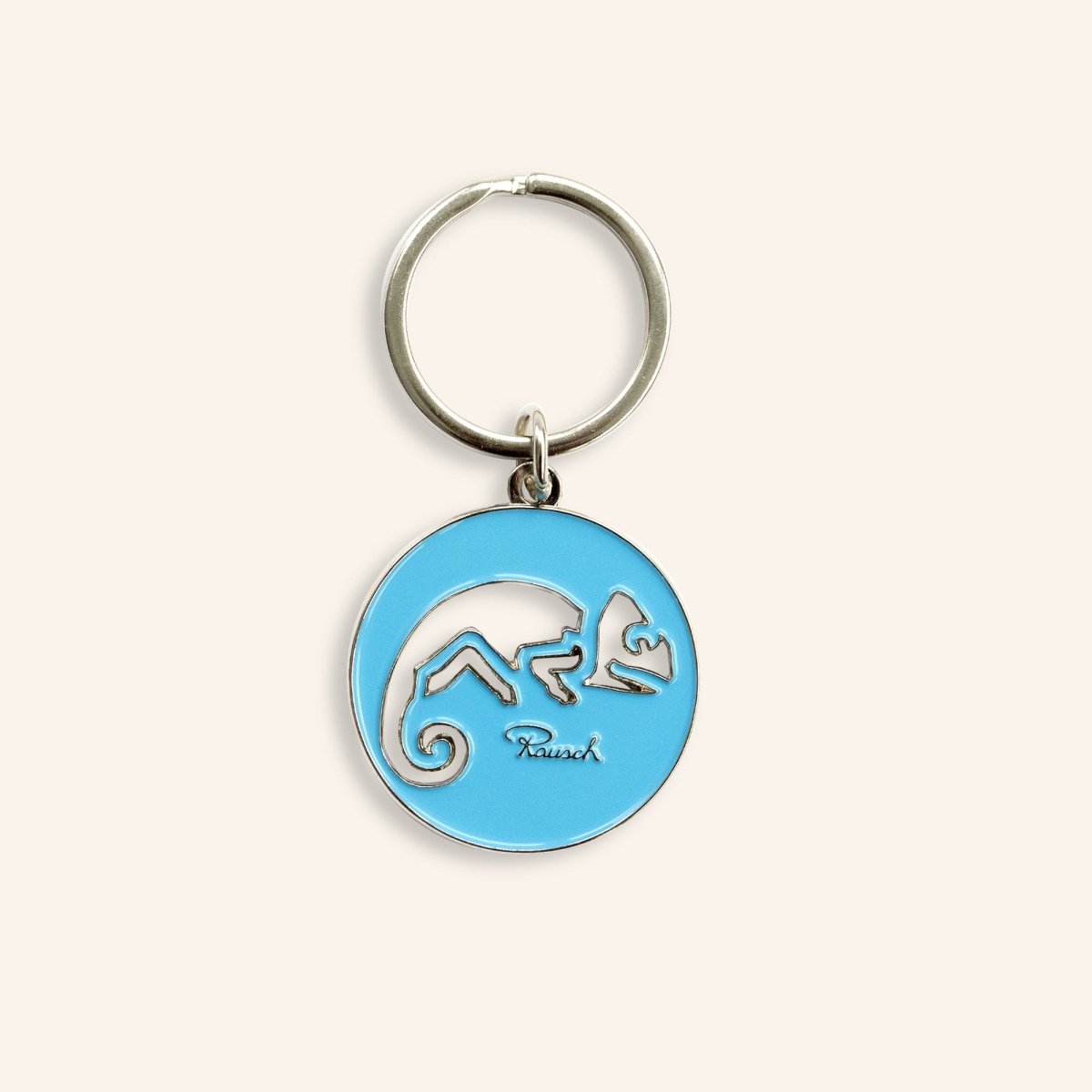 Blauer Schlüsselanhänger mit silbernem Chamäleon-Design und Rausch-Logo.